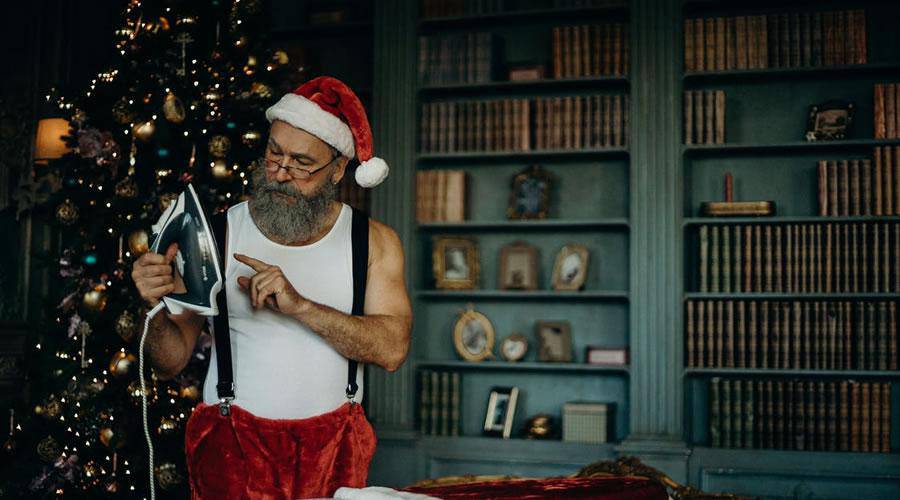 Santa Claus Holding Clothes Iron christmas hd wallpaper desktop high-resolution background