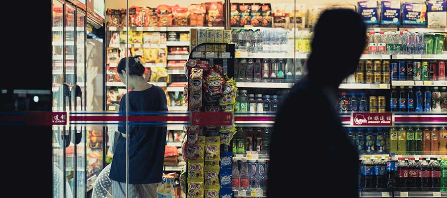 People shopping at a convenience store.