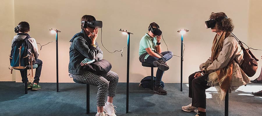 A group of people wearing virtual reality headsets.